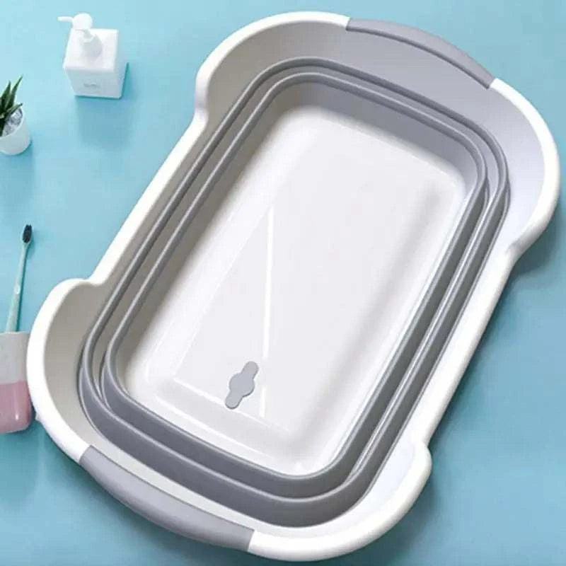 Folding pet bath tub with drainage hole on blue background, portable grooming tub for dogs and cats.