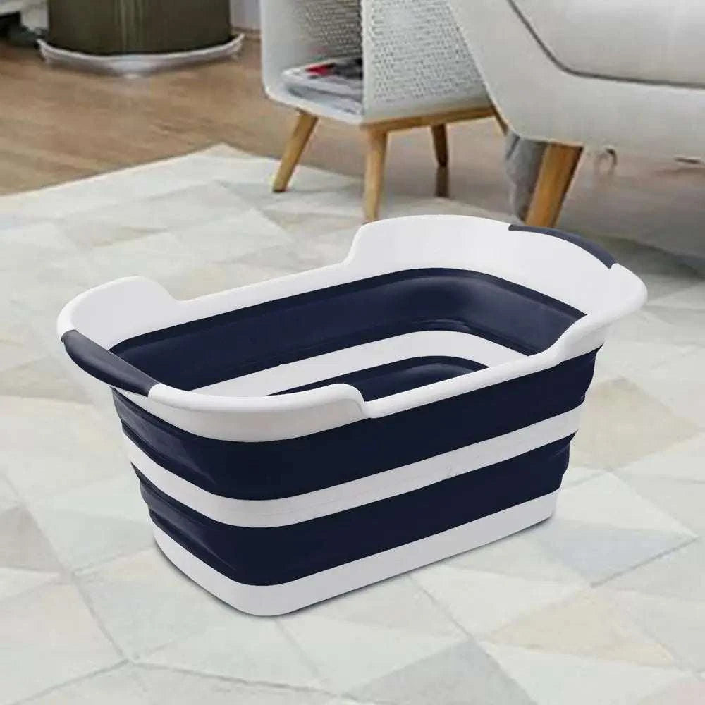Folding pet bath tub with drainage hole, portable dog grooming tub in living room.