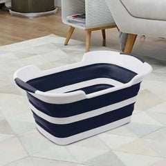 Folding pet bath tub with drainage hole, portable dog grooming tub in living room.