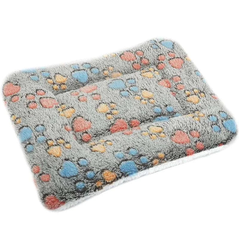 Flannel thickened dog bed mat with paw print design for warmth and comfort.