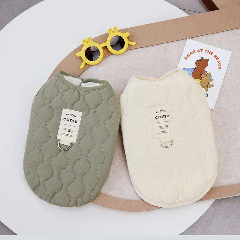 Two quilted winter pet dog vest jackets in green and cream, suitable for small to medium dogs and cats, made of warm cotton fabric.