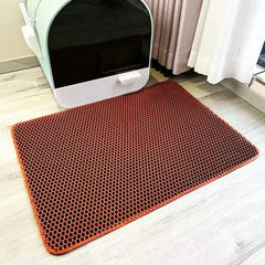 Cat waterproof litter trapping mat with double layer design on floor near litter box.