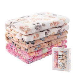 Flannel paw print pet blanket stack, soft no-shed fabric for cats and dogs, machine washable.