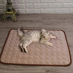 Cat lying on a cooling silk kennel pad for hot summer days.
