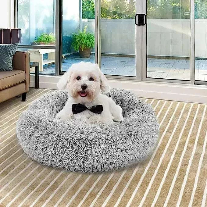 Plush sleeping nest pet bed with a small dog relaxing, ideal for warmth and comfort.
