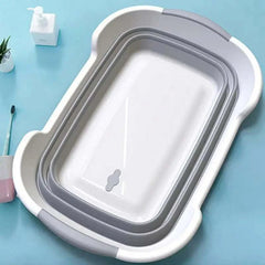 Folding pet bath tub with drainage hole on blue background, portable grooming tub for dogs and cats.
