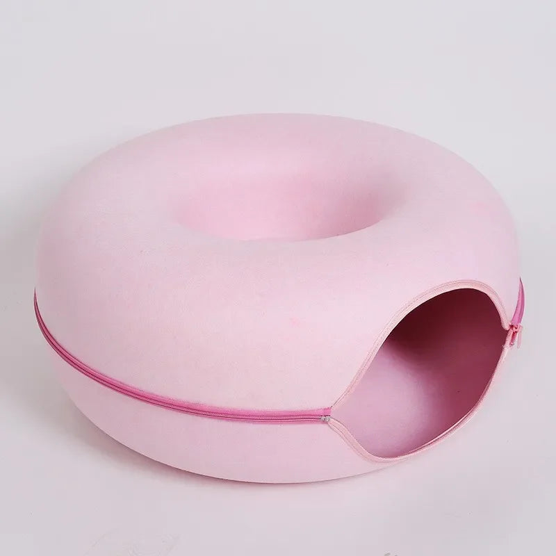 Round cat bed house with soft plush cushion, ideal for small pets, in light pink color.
