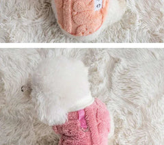 Soft fleece dog clothes in pink and peach for small dogs on a fluffy background.