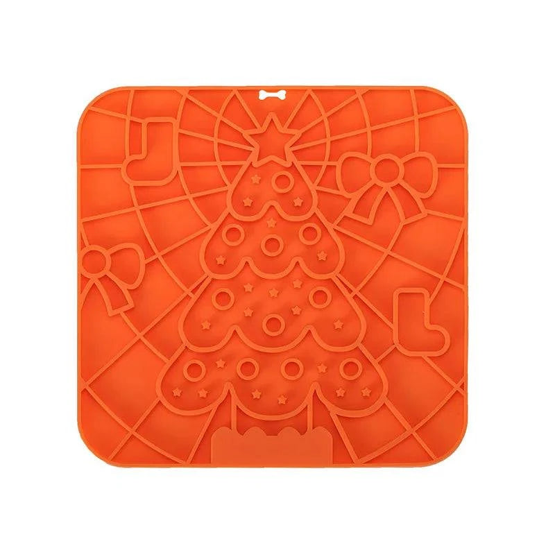 Silicone pet lick mat with a Christmas tree design, slow feeder, bath distraction tool, strong suction, orange color.