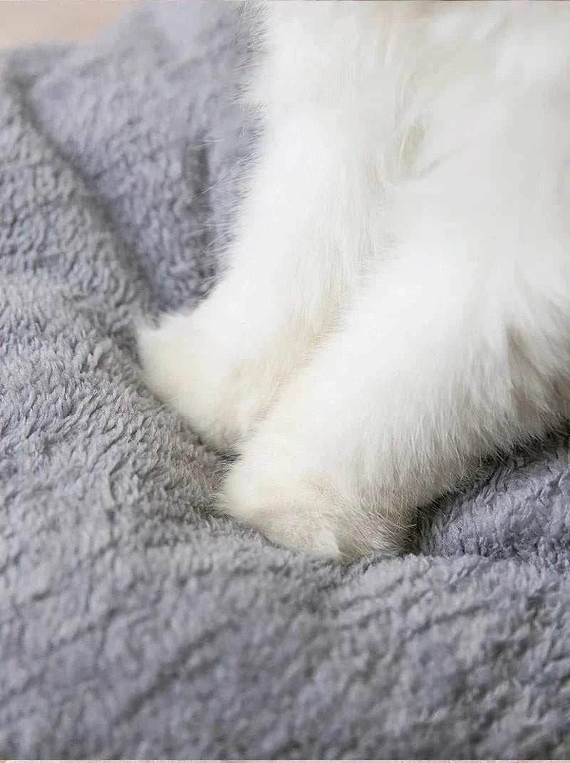 Fluffy small dog bed with soft gray material.