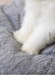 Fluffy small dog bed with soft gray material.