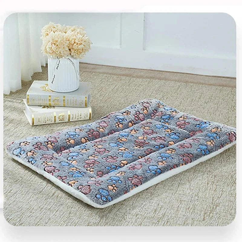 Flannel thickened pet mat with paw print design, soft and warm dog bed blanket for winter.