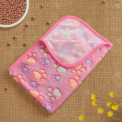 Flannel Paw Print Pet Blanket in pink with colorful paw prints, soft and warm for cats and dogs.