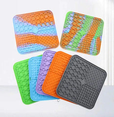 Silicone pet lick mats in various colors for slow feeding and bath distraction.