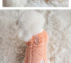 Soft fleece dog sweater for small dogs, winter warm pullover in peach on fluffy white rug.