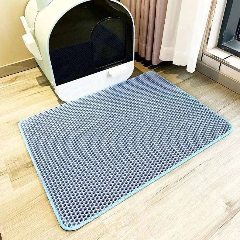 Cat waterproof litter trapping mat with double layer design next to litter box.
