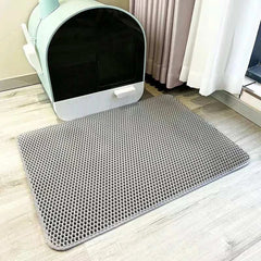 Cat waterproof litter trapping mat with double-layer design, non-slip backing, and washable material placed beside litter box.