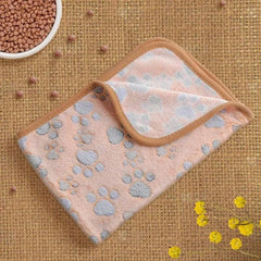 Flannel paw print pet blanket, soft and warm, no-shed design for cats and dogs.