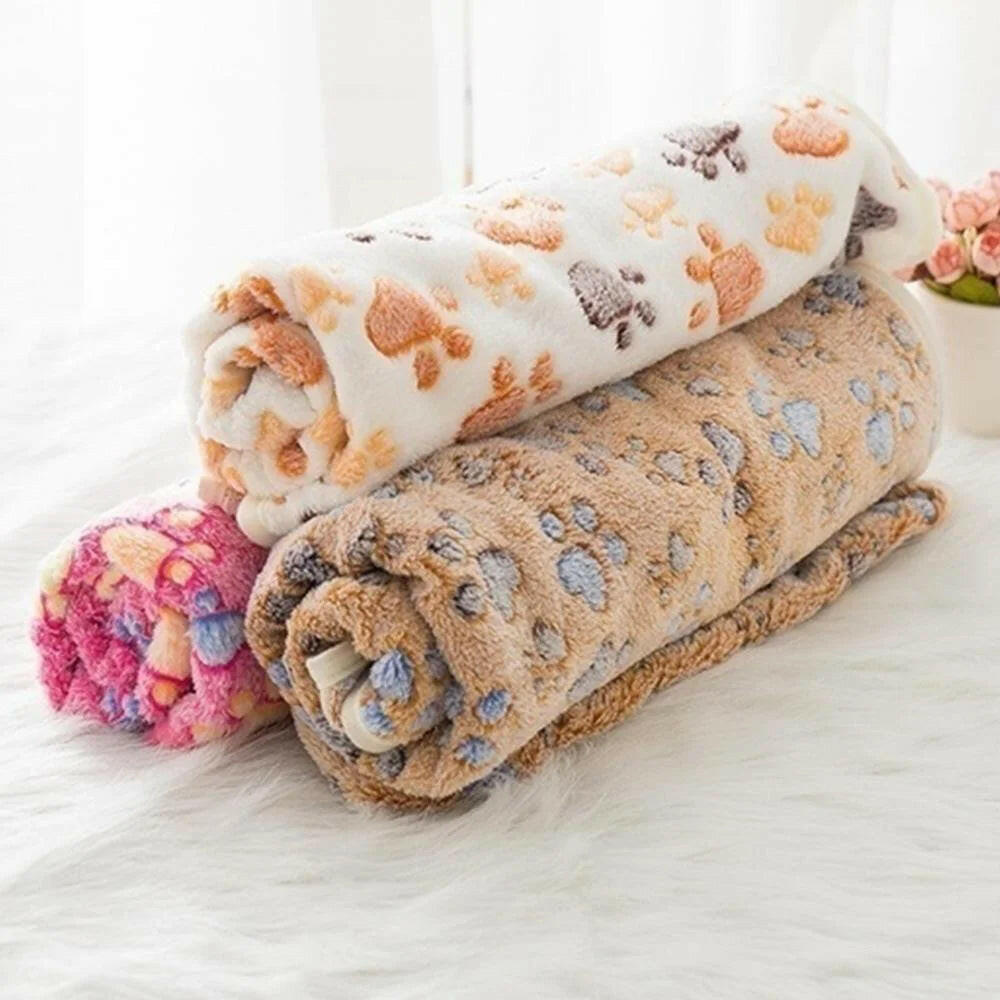 Soft fluffy cartoon pet blanket rolled up with paw print design, cozy and warm mat for cats and dogs.