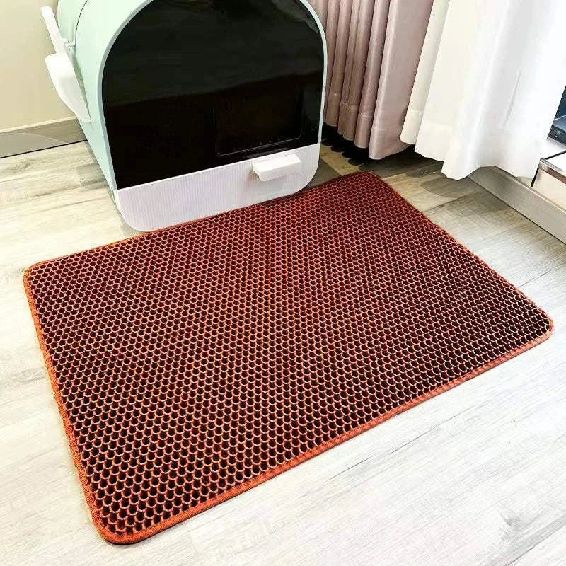 Cat waterproof litter trapping mat with double layer design on floor near litter box.